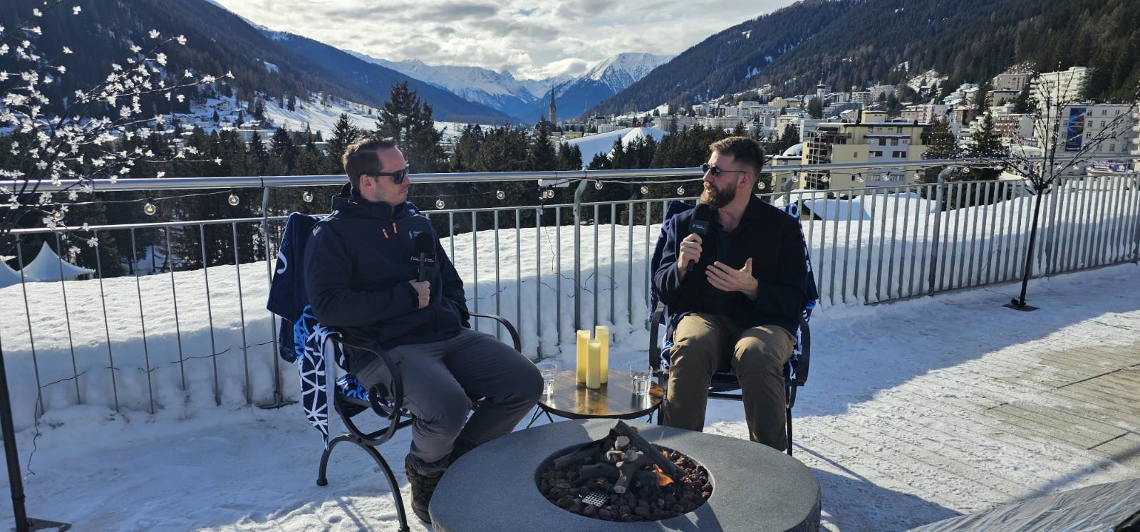 Aaron Stanley hosting a conversation on a Davos terrace overlooking the Alps